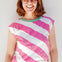Woman wearing a pink and white striped sleeveless top against a light background