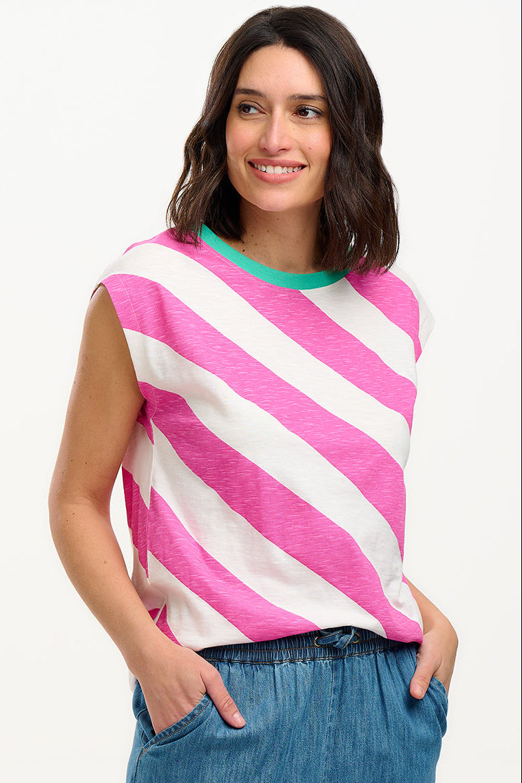 Sugarhill Brighton t-shirt. A female model wearing an oversized sleeveless striped t-shirt in pink and white, paired with blue jeans.