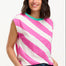 Sugarhill Brighton t-shirt. A female model wearing an oversized sleeveless striped t-shirt in pink and white, paired with blue jeans.