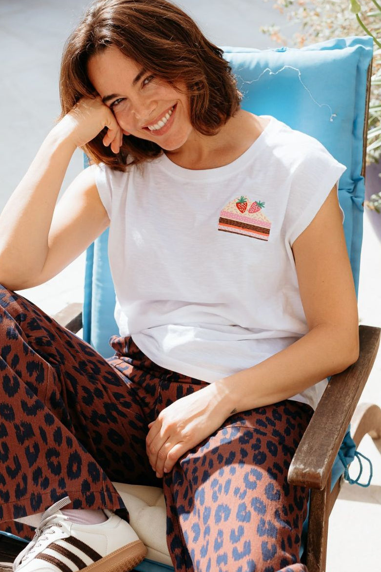 Woman wearing a white t-shirt with a colourful strawberry design