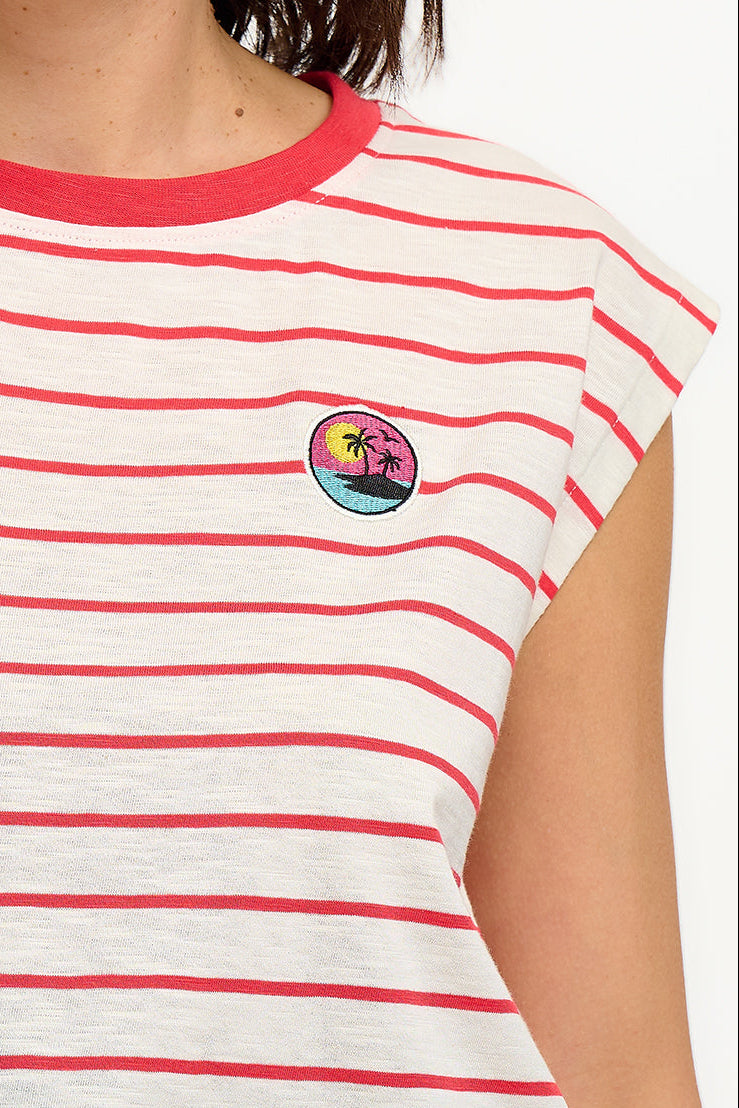 Woman wearing a red and white striped shirt with a colorful logo on a white background