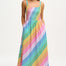 A woman wearing a multicolored rainbow checkerboard sundress with shirred top and midi length.