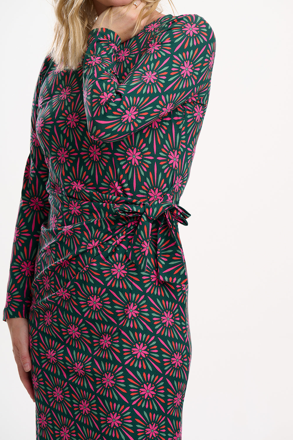 Green and pink floral patterned dress on a white background