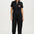 Woman wearing a black jumpsuit with a colorful design on a white background