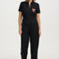 Woman wearing a black jumpsuit with a colorful design on a white background