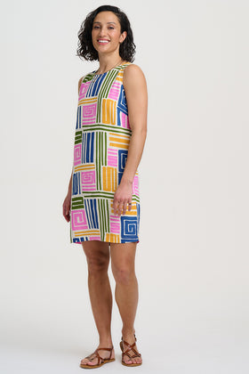 Woman wearing a colorful geometric patterned dress on a white background