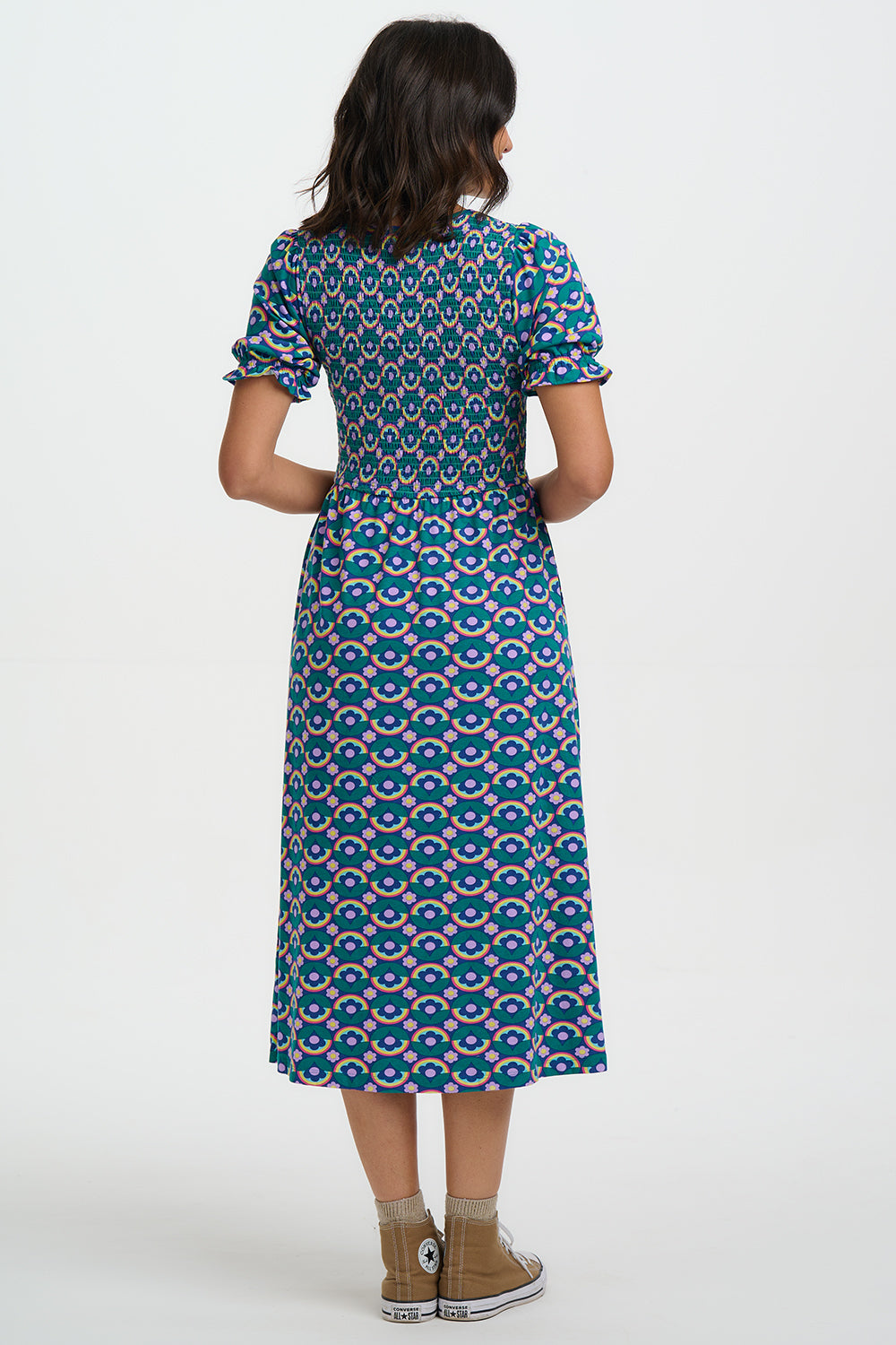 Woman wearing a blue patterned dress on a white background