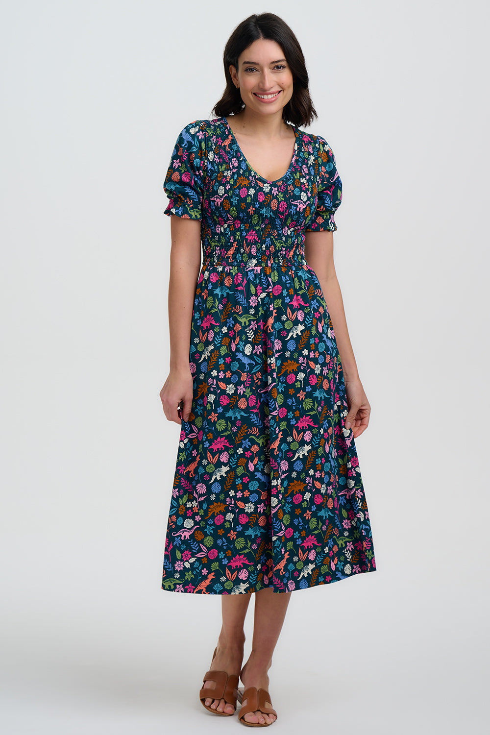 Woman wearing a colorful floral dress on a white background
