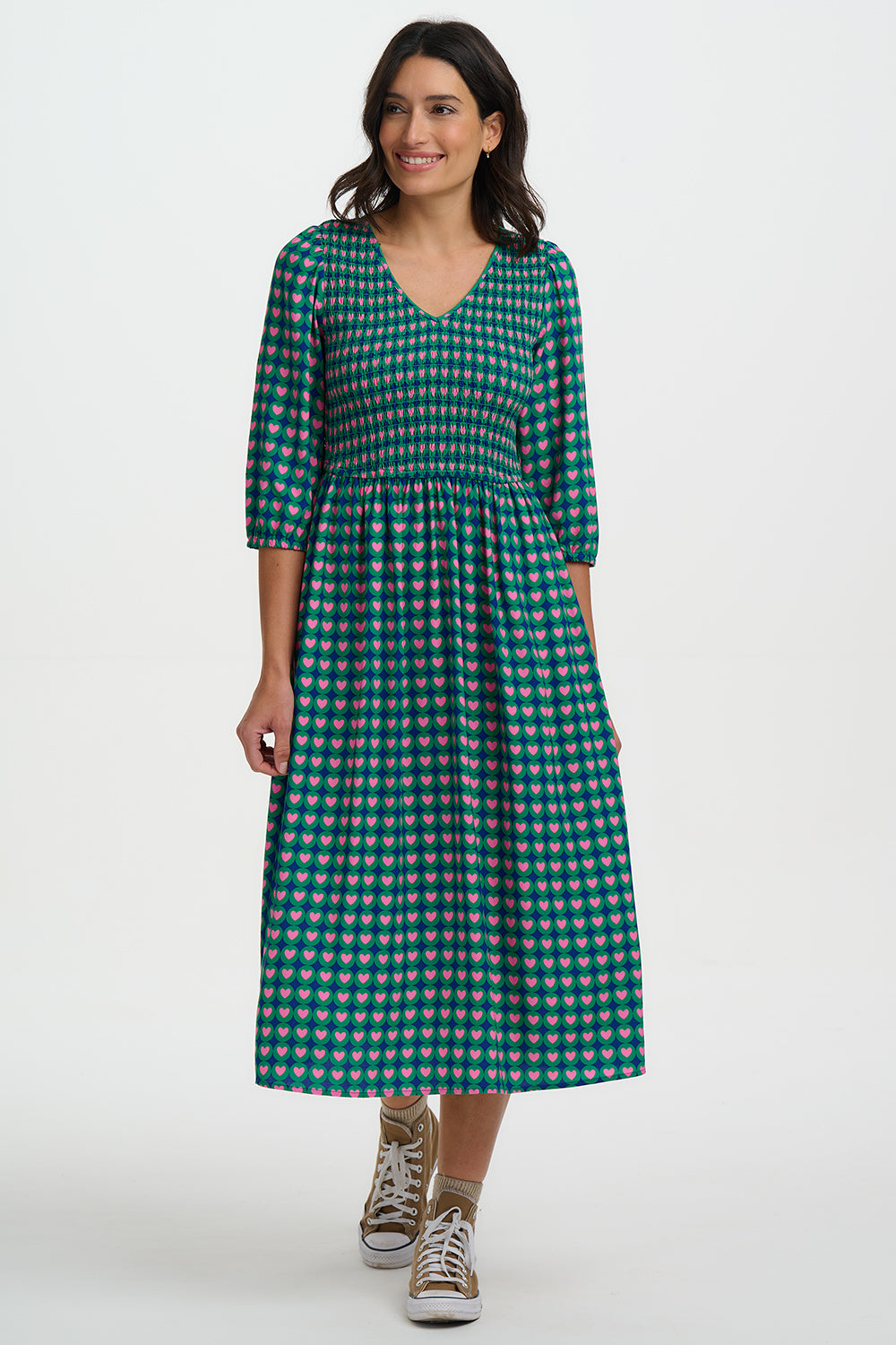 Woman wearing a green checkered dress on a white background