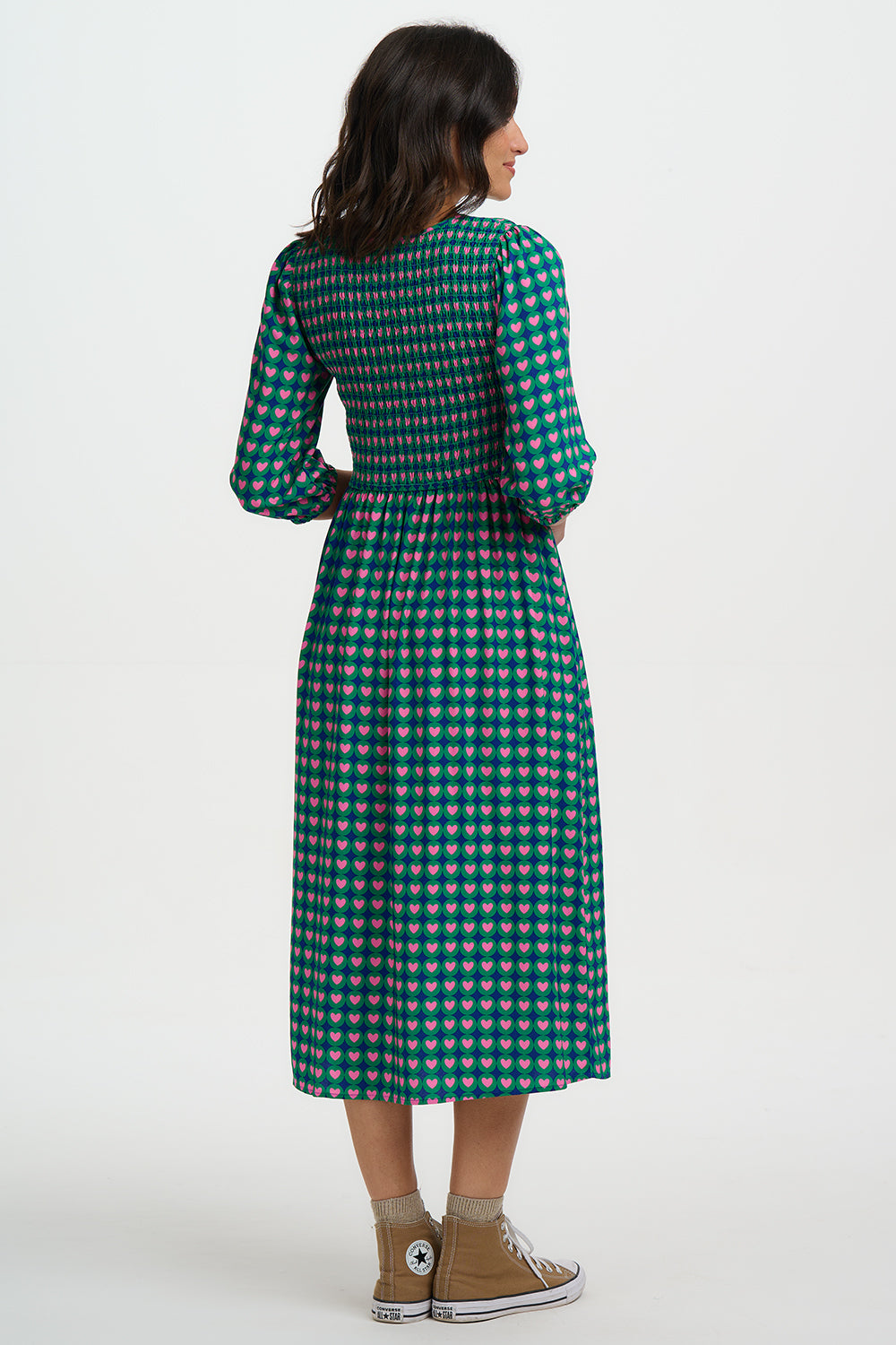 Woman wearing a green checkered dress on a white background