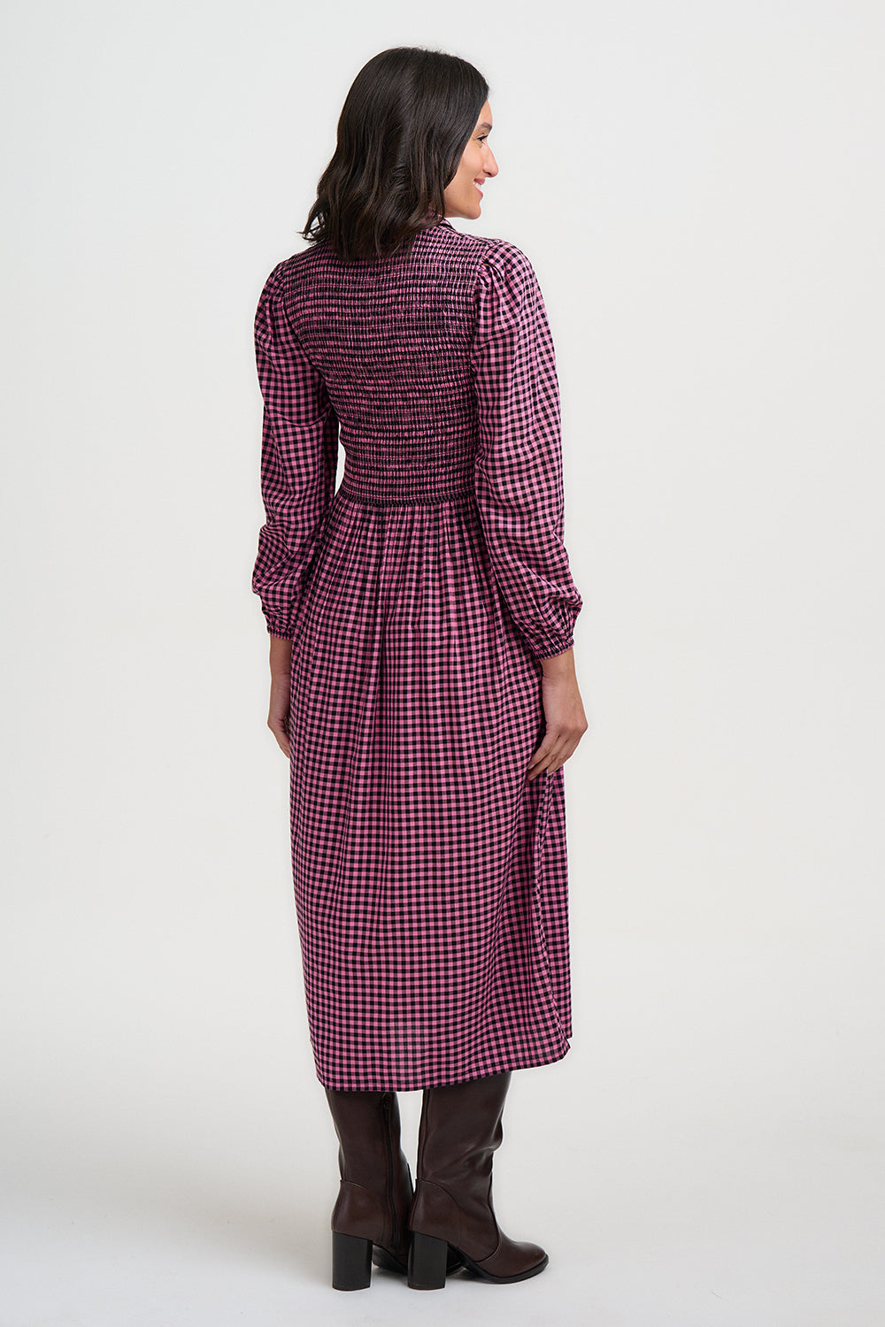 Woman wearing a purple checkered dress on a white background