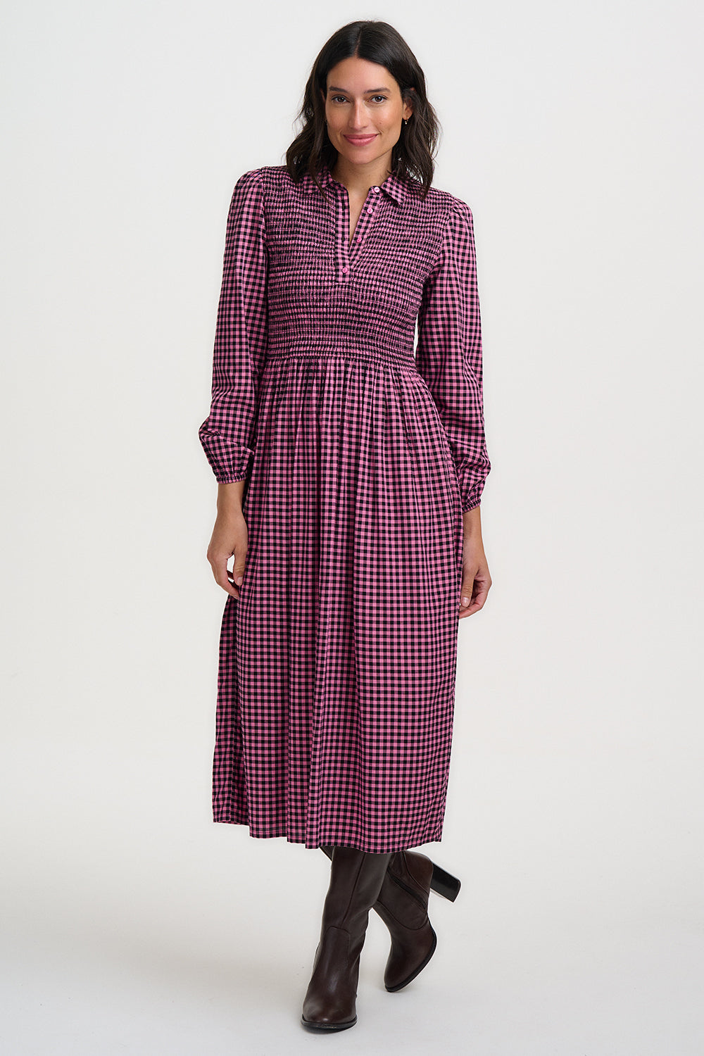 Woman wearing a purple checkered dress on a white background
