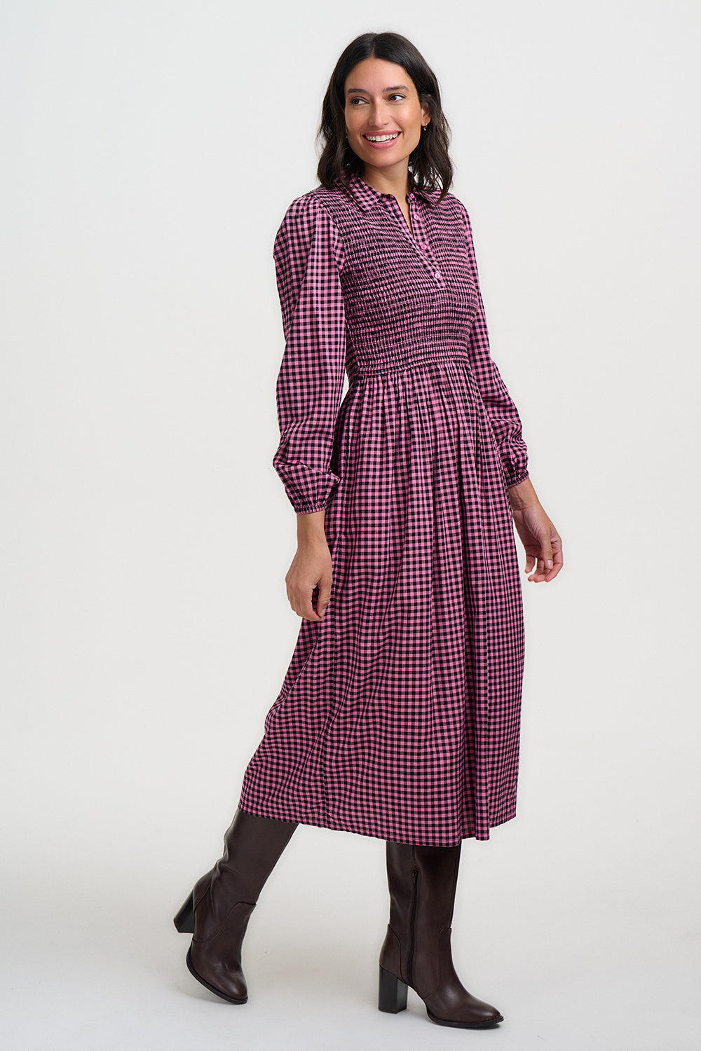 Woman wearing a purple checkered dress on a white background