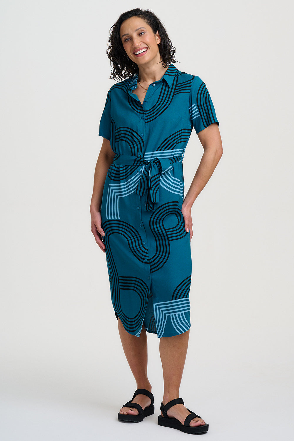 Woman wearing a blue patterned dress on a white background