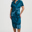 Woman wearing a blue patterned dress on a white background