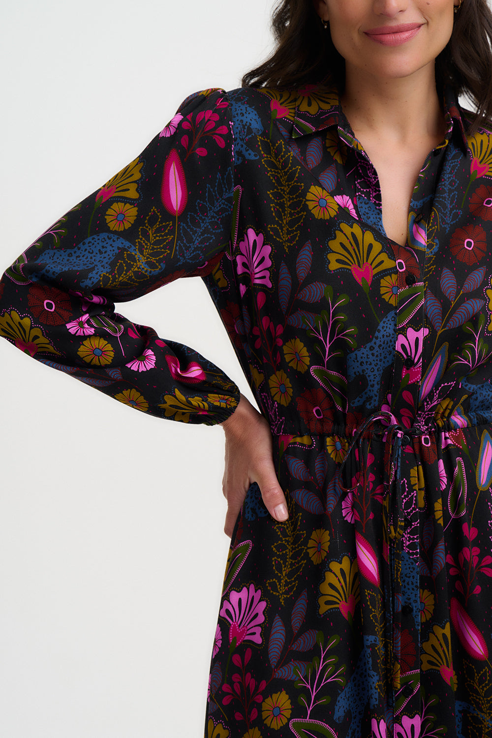 Woman wearing a floral patterned dress with a white background