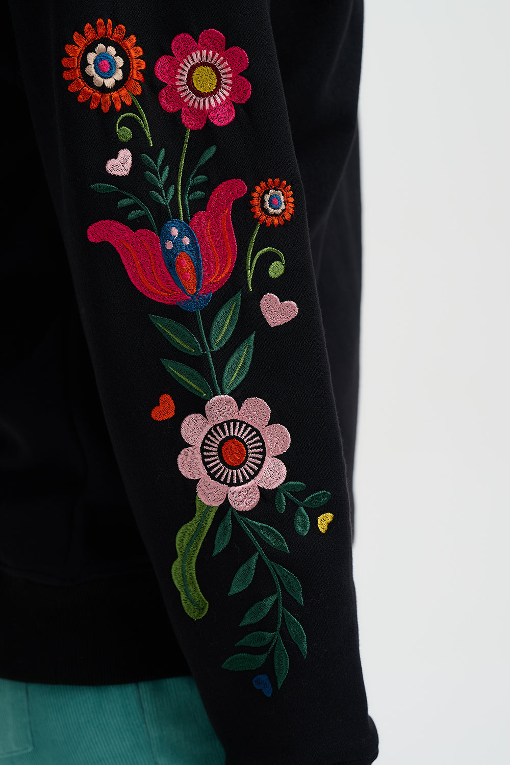 Embroidered floral design on a black fabric background