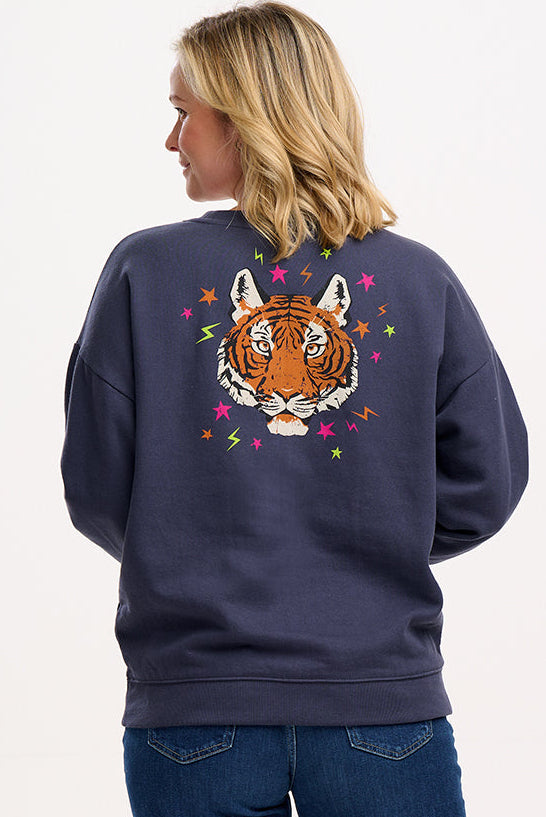 model wearing charcoal sweatshirt with large tiger motif