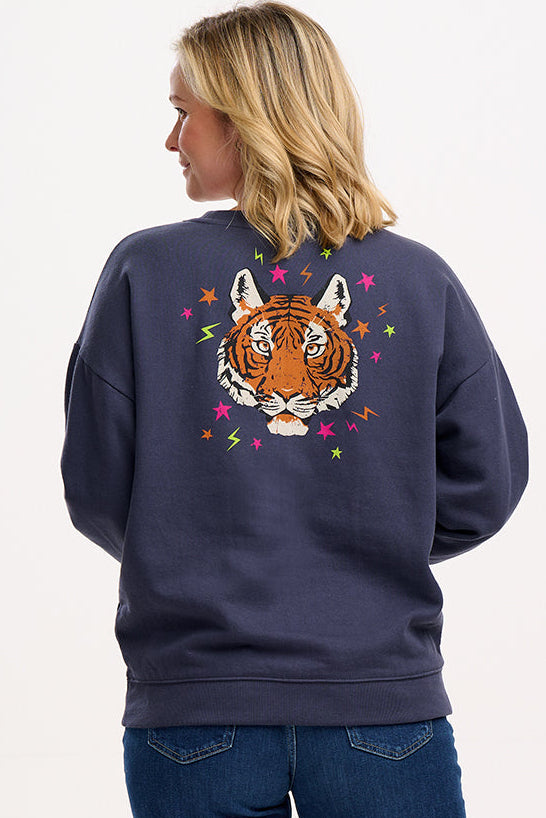 model wearing charcoal sweatshirt with large tiger motif