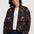 Woman wearing a colorful floral-patterned jacket on a white background