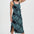 Woman wearing a blue patterned dress on a white background