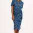 A model wearing a bright navy blue jersey midi dress with a star and snake pattern, featuring short sleeves and a waist tie.