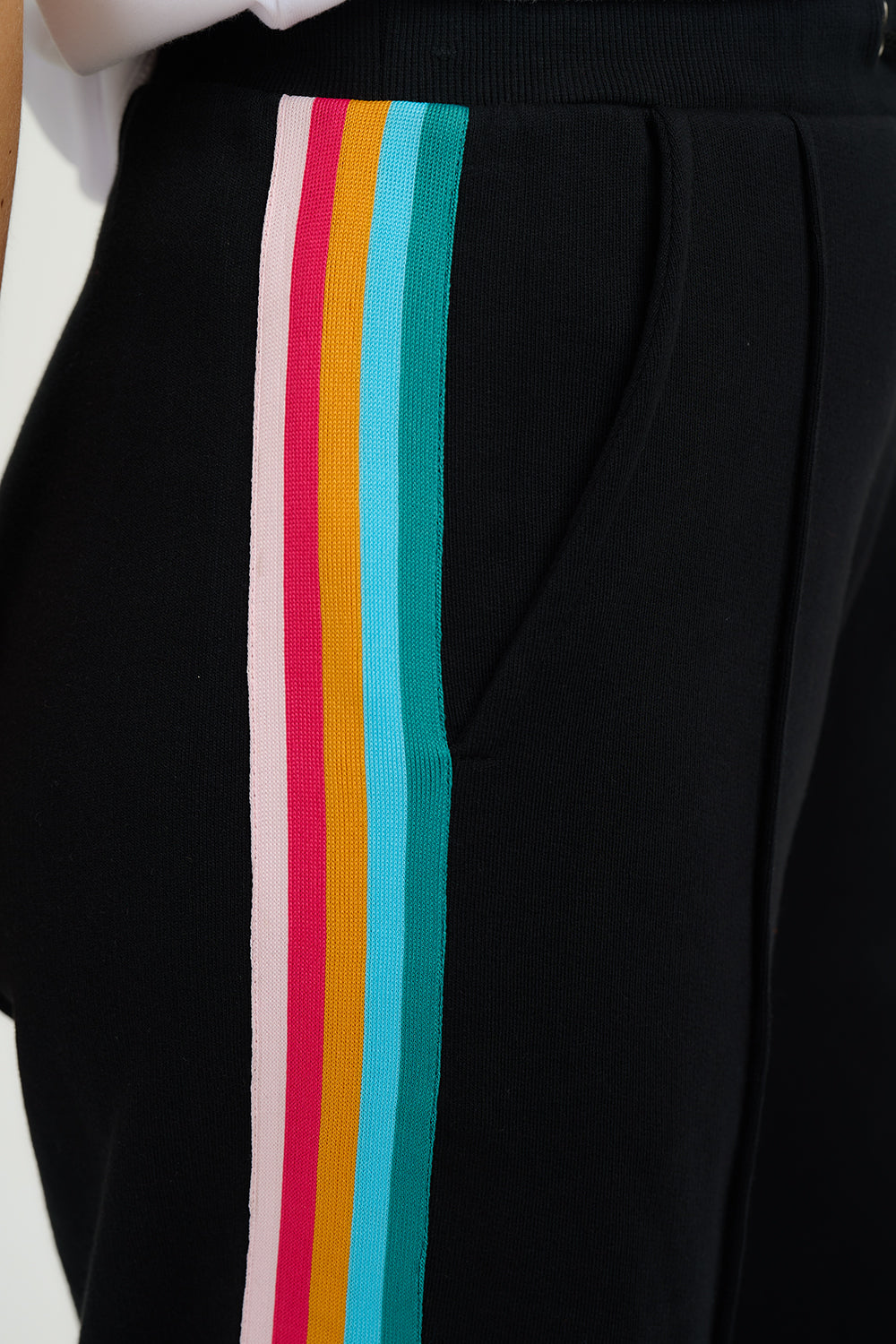 Black pants with colorful stripes on a white background