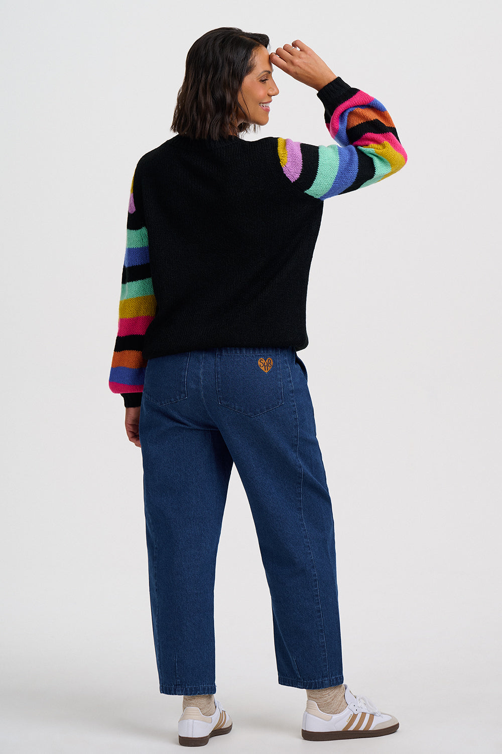Black cardigan with colorful striped sleeves on a white background