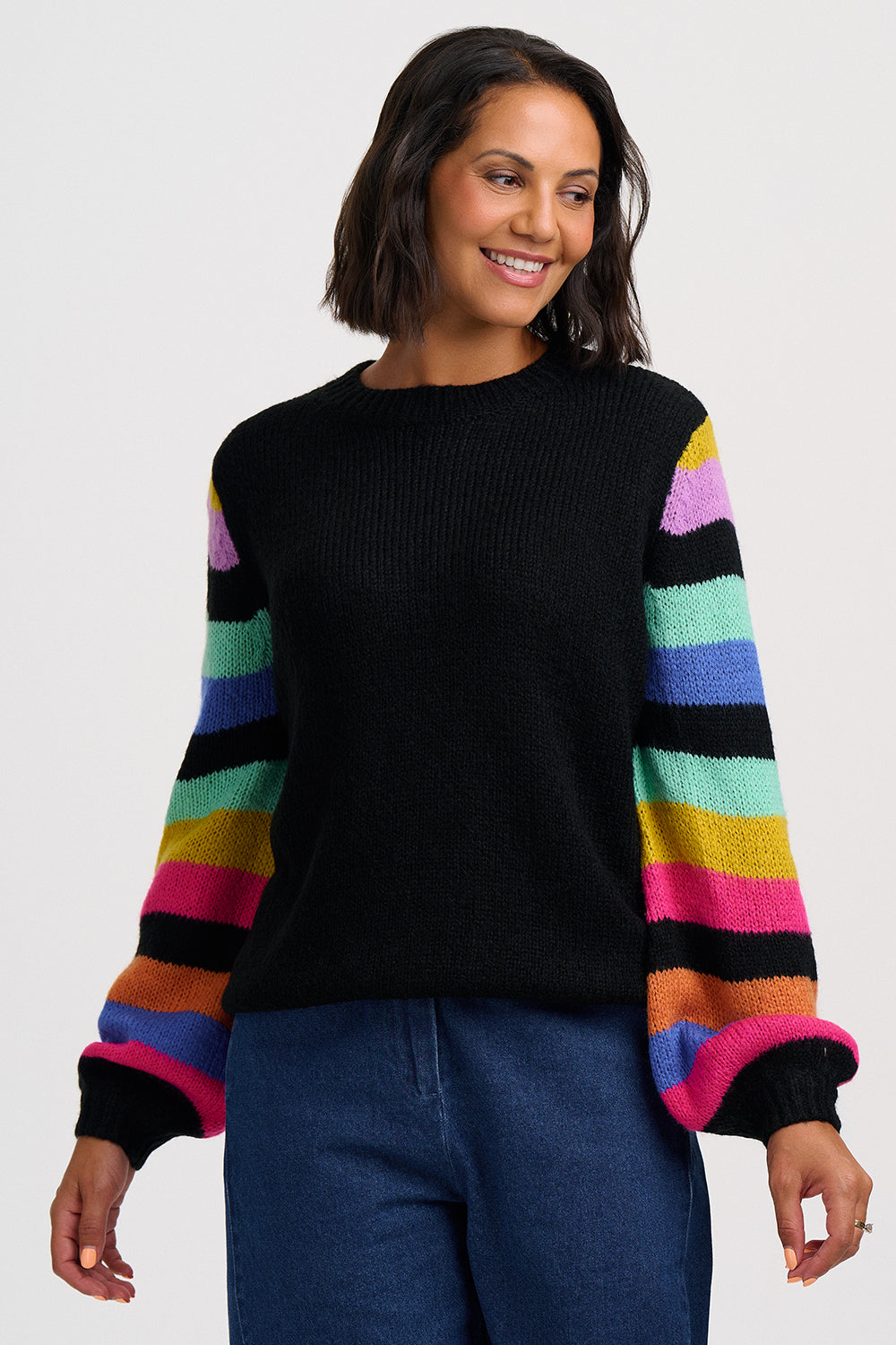 Black jumper with colorful striped sleeves on a white background