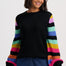 Black jumper with colorful striped sleeves on a white background