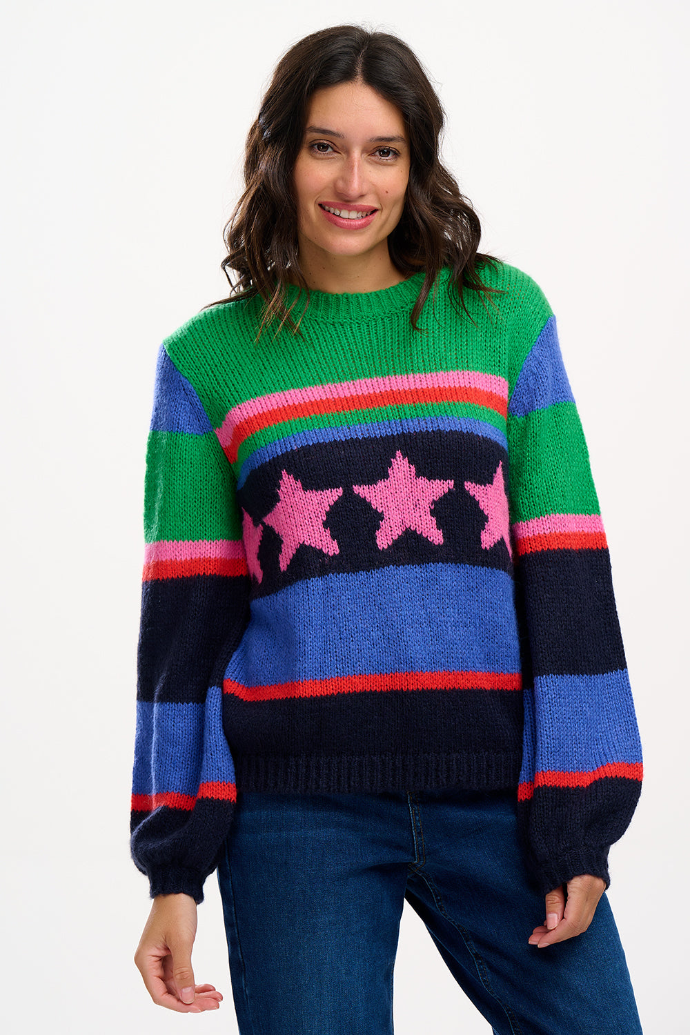A woman wearing a colorful striped sweater with a pattern of stars.