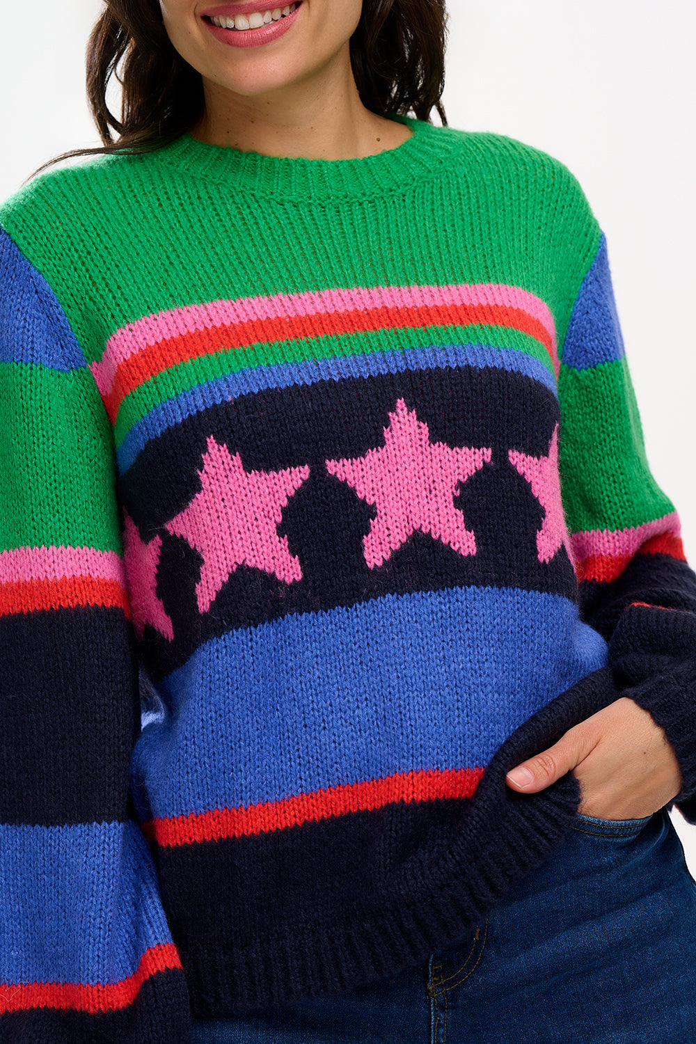 A woman wearing a colorful striped sweater with a pattern of stars.