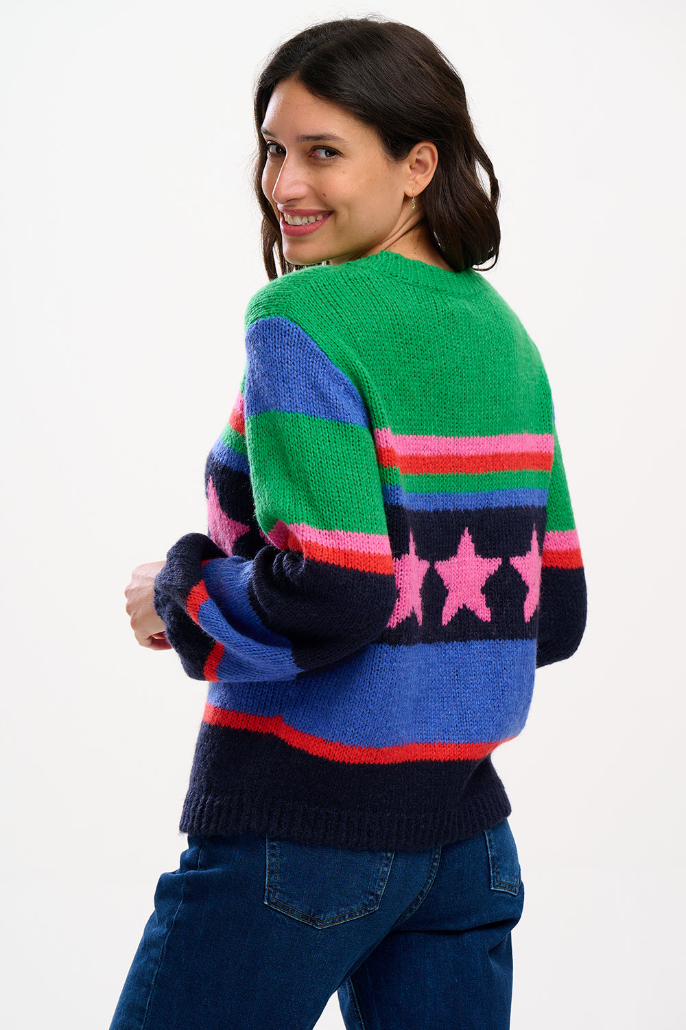 A woman wearing a colorful striped sweater with a pattern of stars.