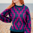 Woman wearing a patterned sweater on a beach
