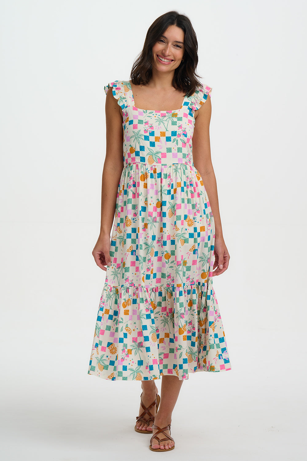 Woman wearing a colorful checkered dress on a white background