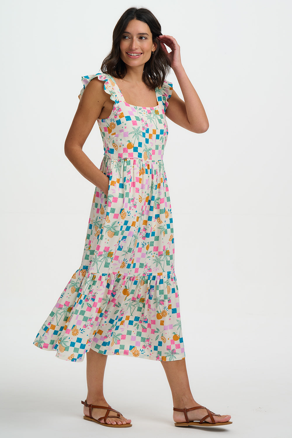 Woman wearing a colorful patterned dress on a white background