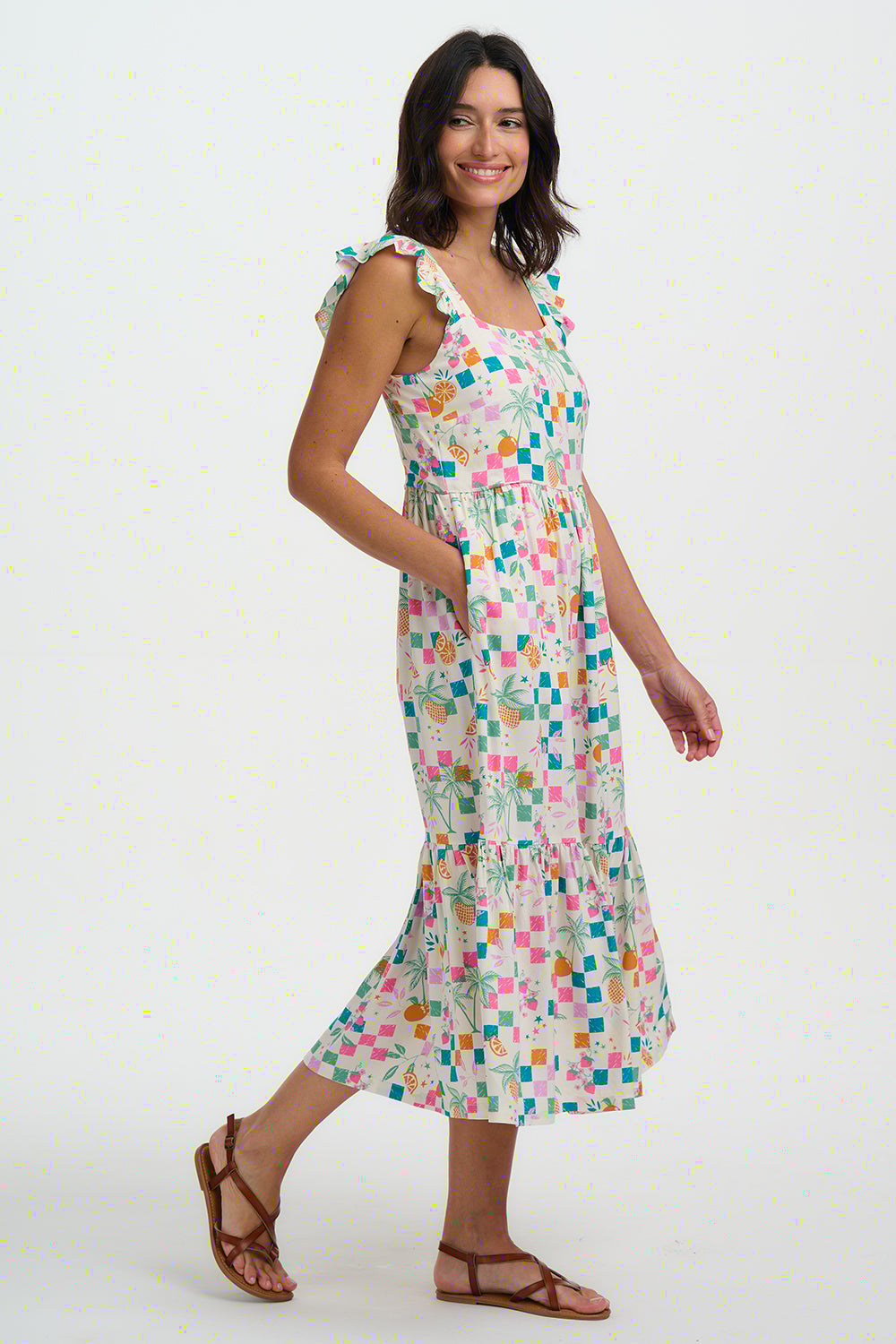 Woman wearing a colorful patterned dress on a white background