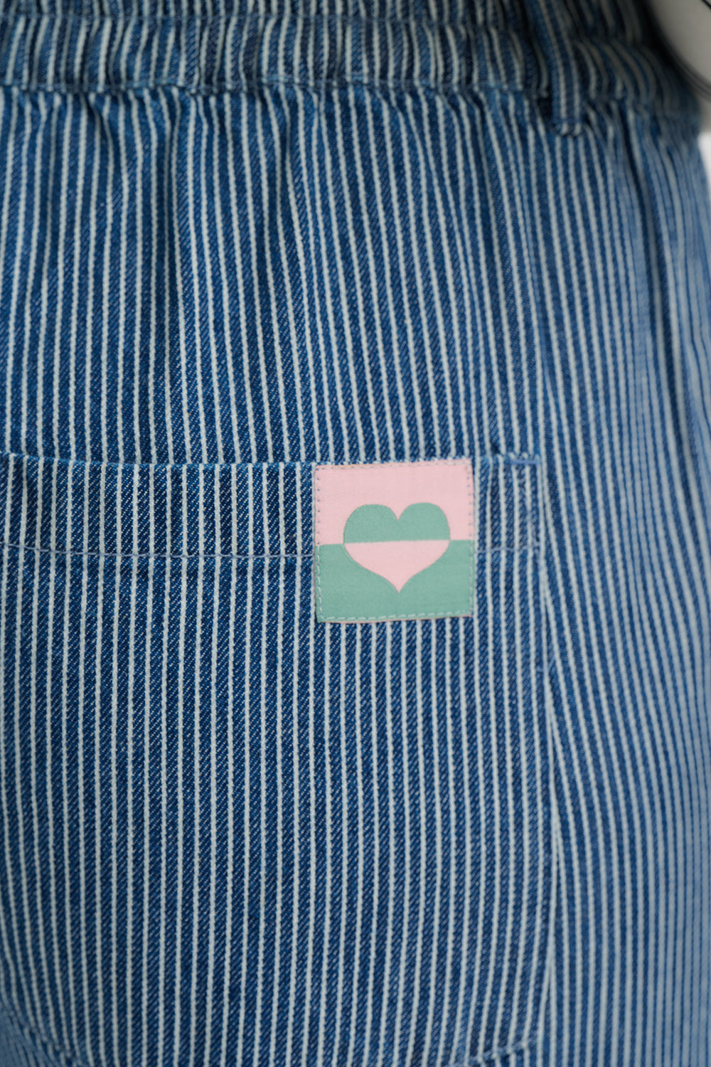 Blue striped fabric with a pink and green heart label