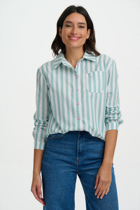 Woman wearing a green and white striped shirt with blue jeans on a white background