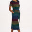 A model wearing a midi-length jersey dress with a black background featuring a vibrant multicolour striped pattern. The dress has a t-shirt fit with a matching tie belt and short sleeves.