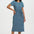 Woman wearing a blue patterned dress on a white background