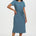 Woman wearing a blue patterned dress on a white background