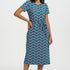 Woman wearing a blue patterned dress on a white background