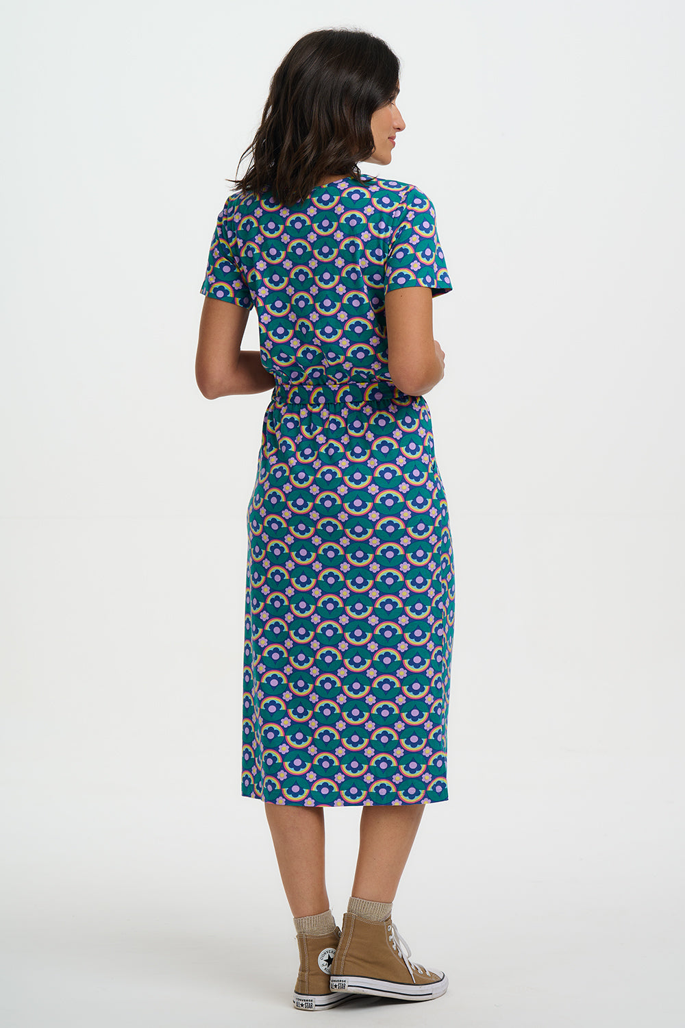 Woman wearing a patterned dress on a white background