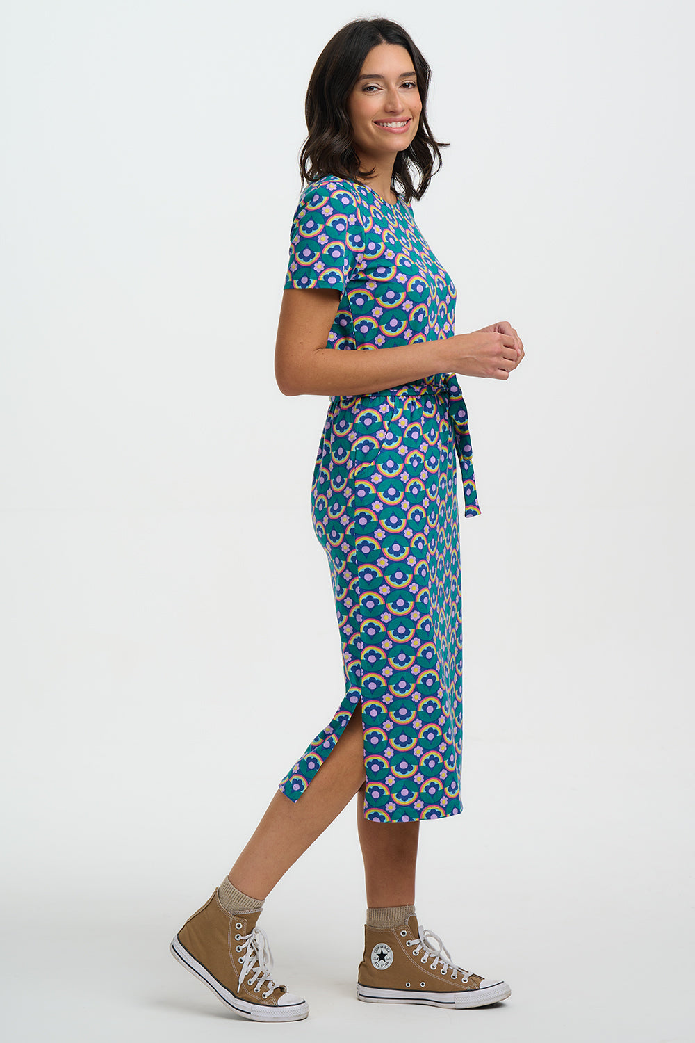 Woman wearing a patterned dress with a white background