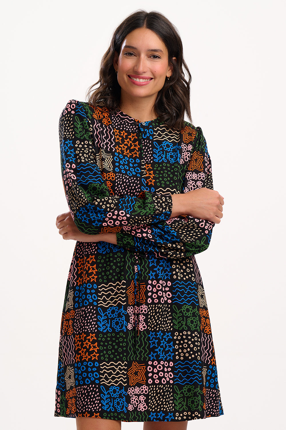 Woman wearing a colorful patterned dress on a white background