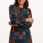 Woman wearing a colorful patterned dress on a white background