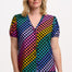 A woman wearing a short-sleeved, multicolored checkered blouse with frill trim and elasticated cuffs, paired with jeans.
