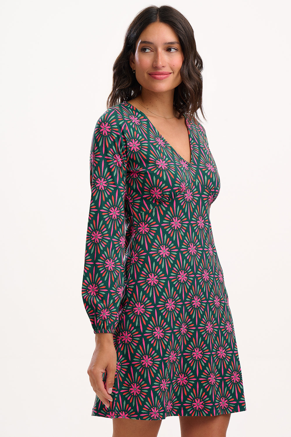 Sugarhill brighton model wearing a patterned dress with long sleeves on a white background