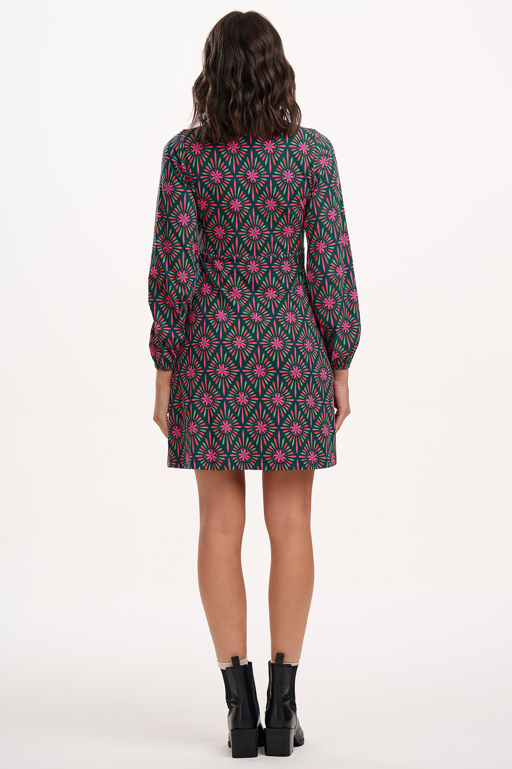 Suagrhill brighton model wearing a patterned dress on a white background